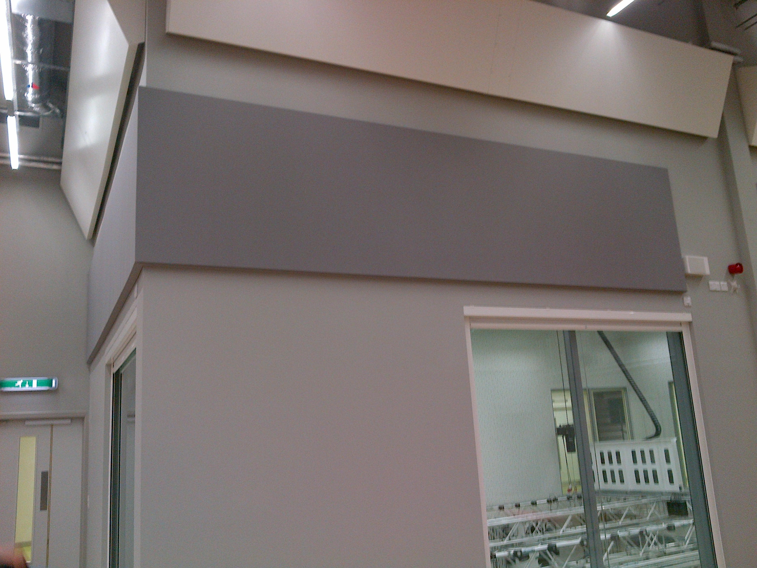 Architectural acoustic wall panelling integrated around an internal doorway
