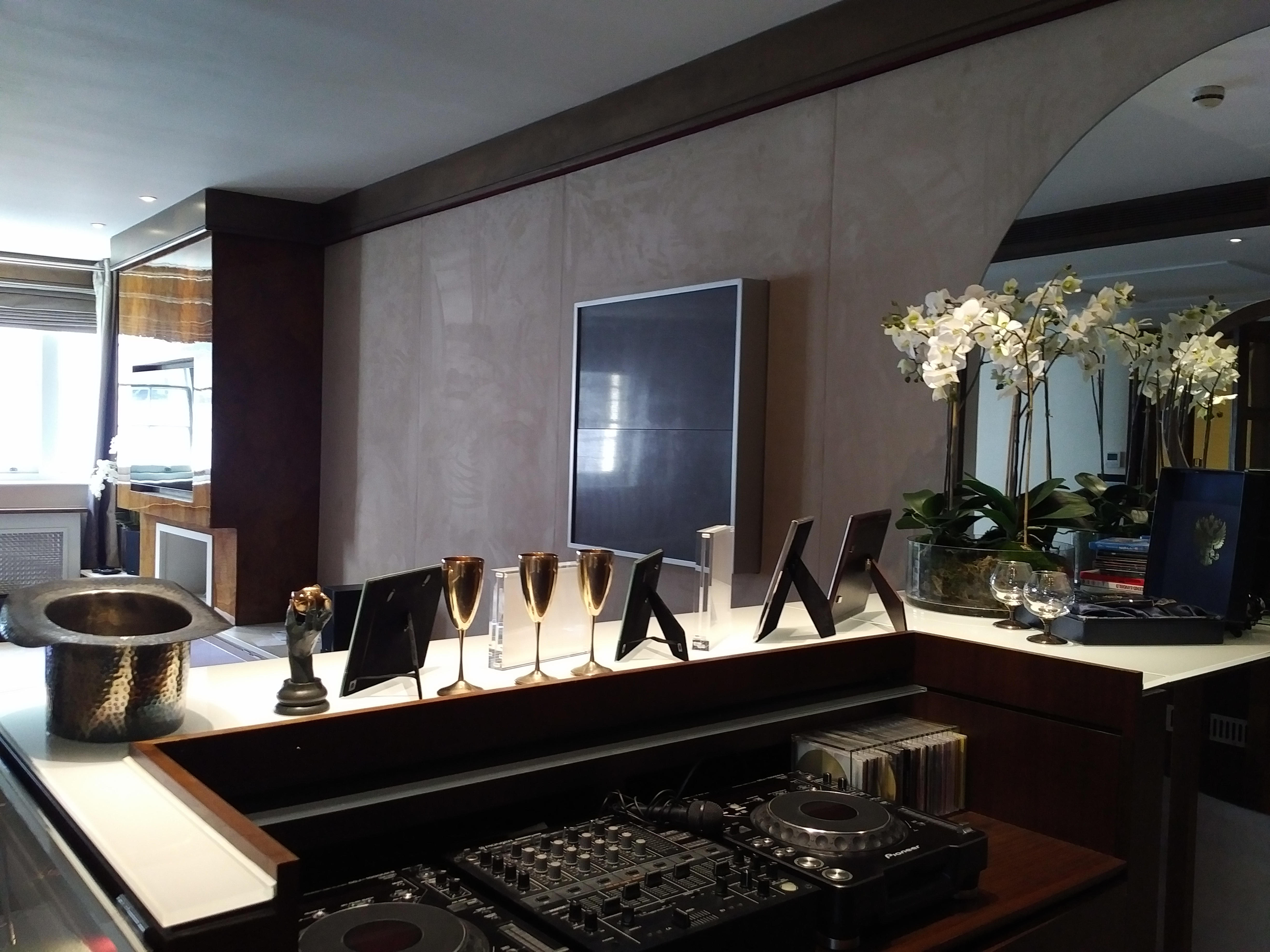Elegant bar area with decorative glasses, orchids and ambient lighting