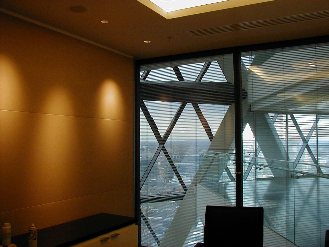Stretch fabric acoustic wall system installed beside full-height glazing in a commercial interior
