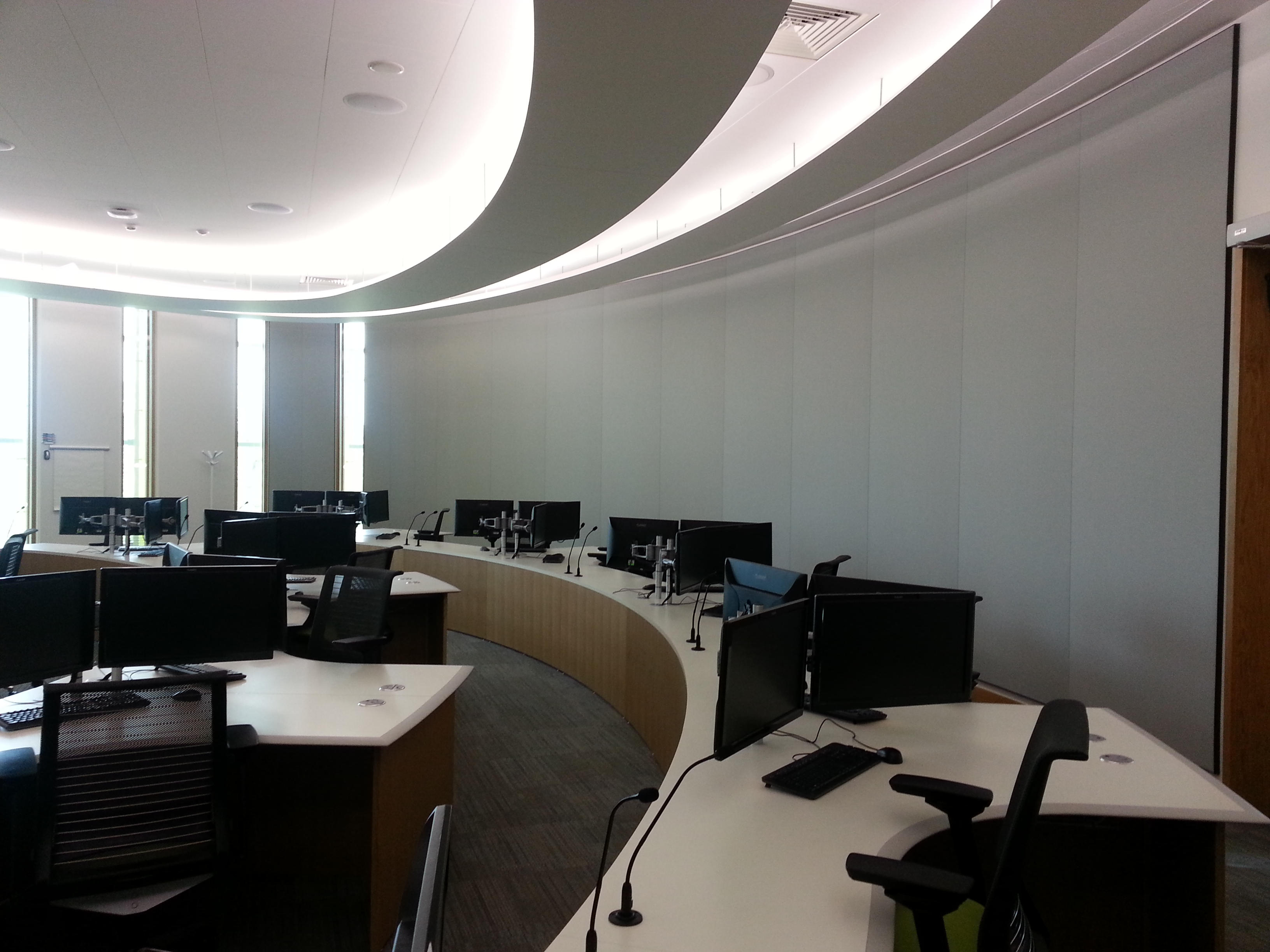 Modern office space with multiple computer workstations and a curved desk layout