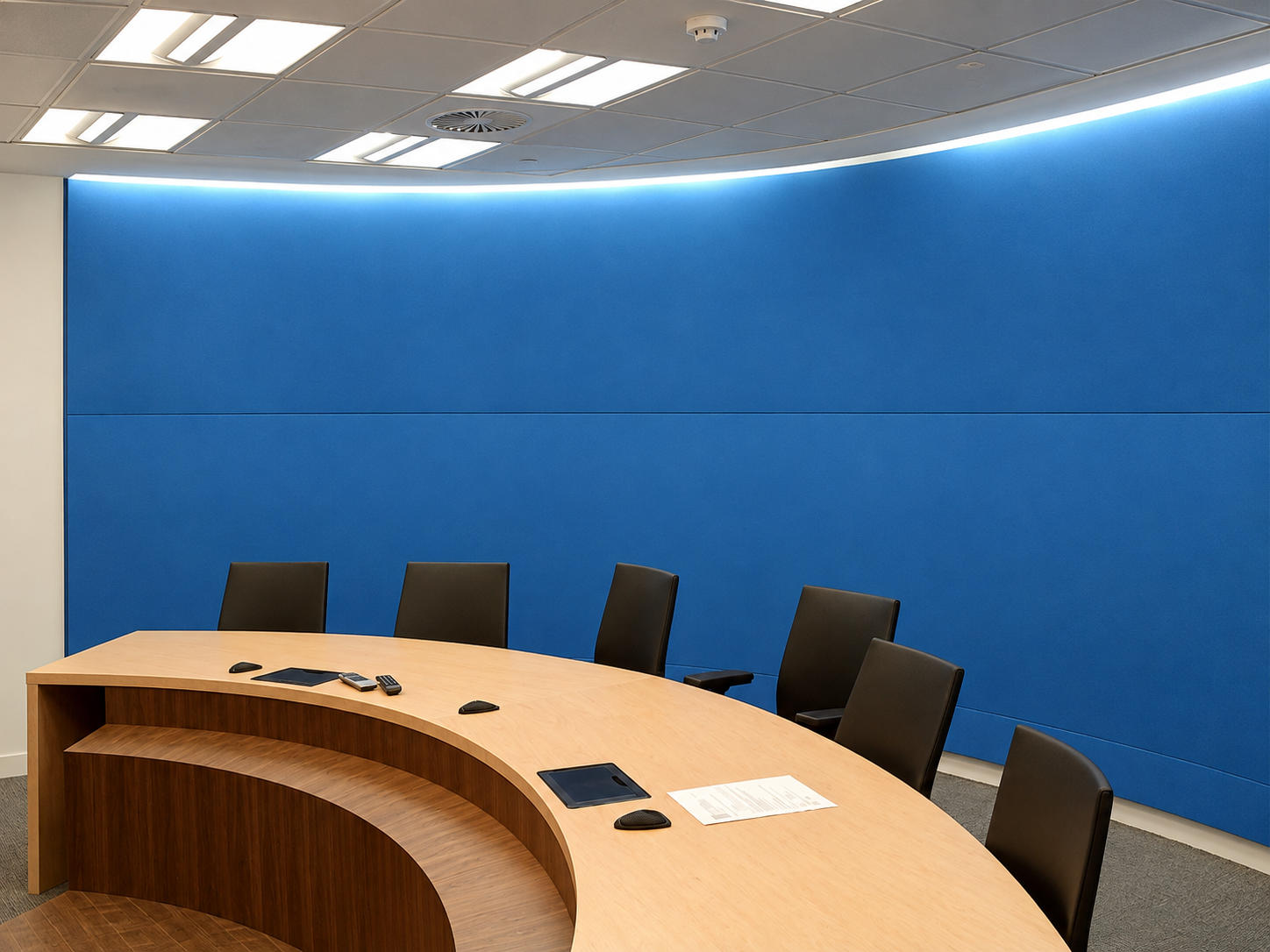 Modern conference room with a curved wooden table